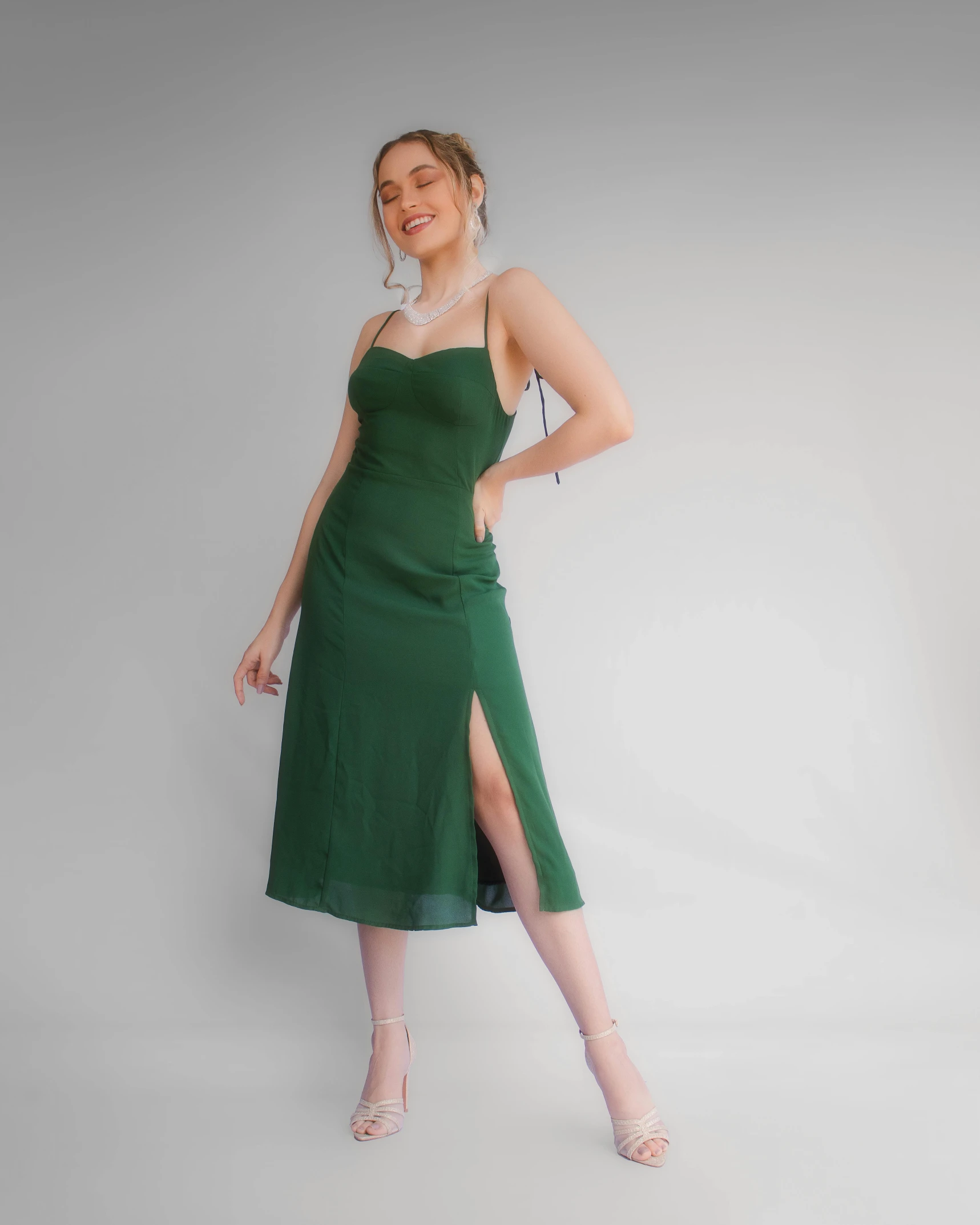 a woman wearing a green midi dress