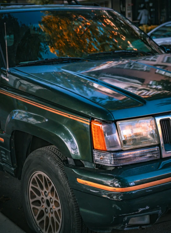 a black and green vehicle parked by a curb