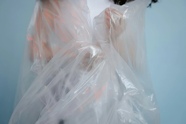 woman wrapped in plastic on the blue background