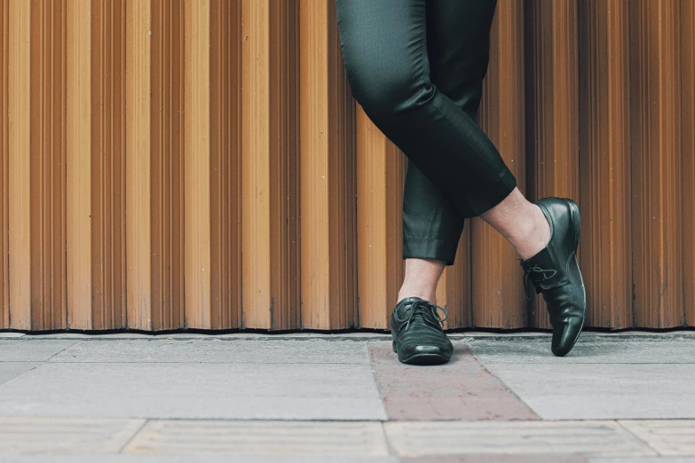 close up of a person wearing black shoes