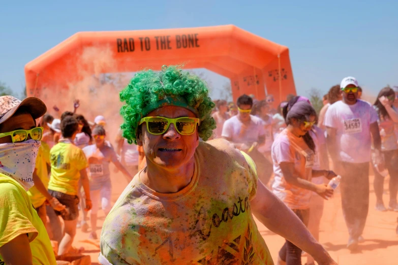 a group of people covered in colors standing around