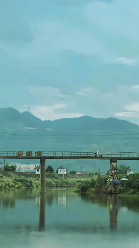 a train on a bridge over a lake