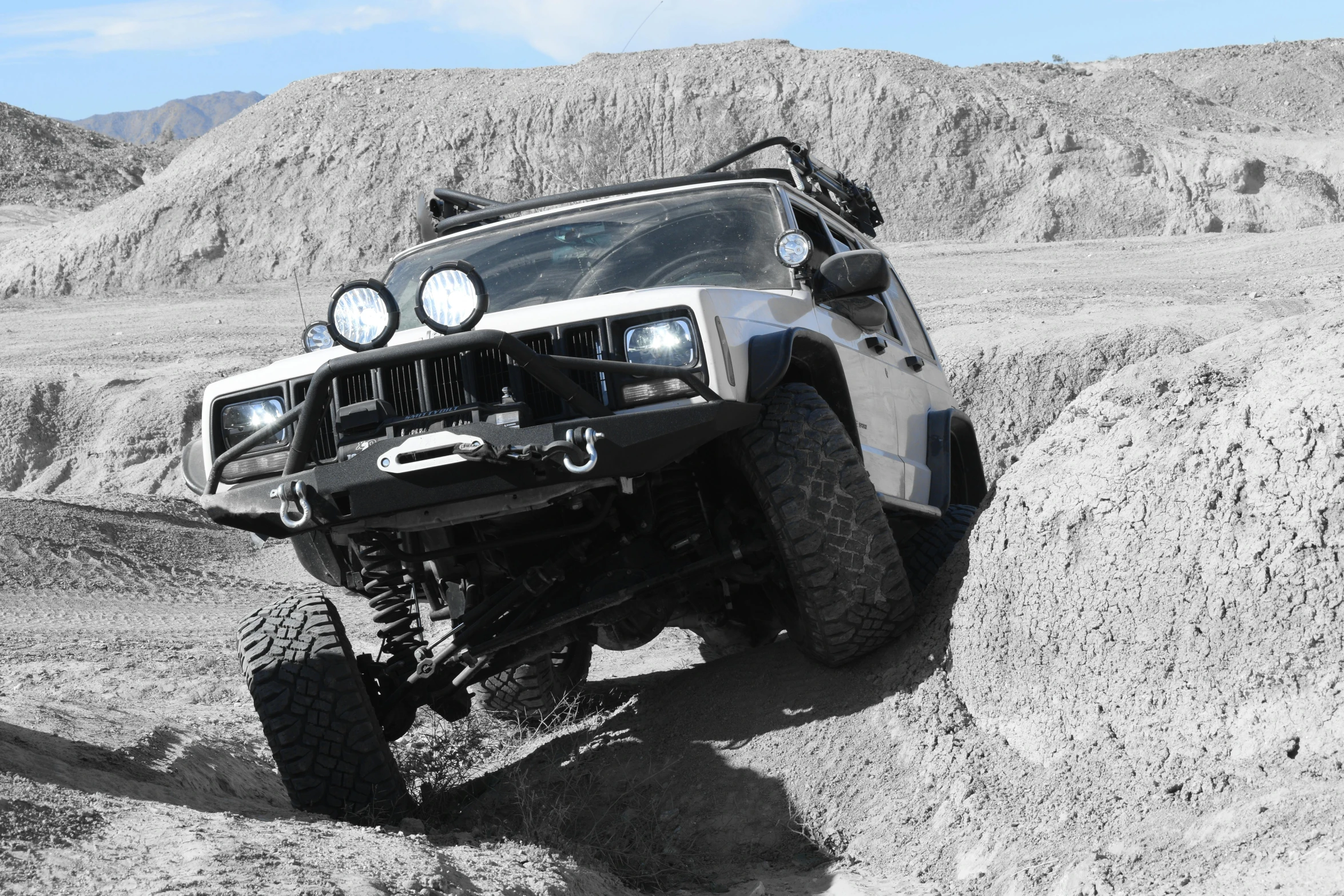 an off road vehicle going down some sand