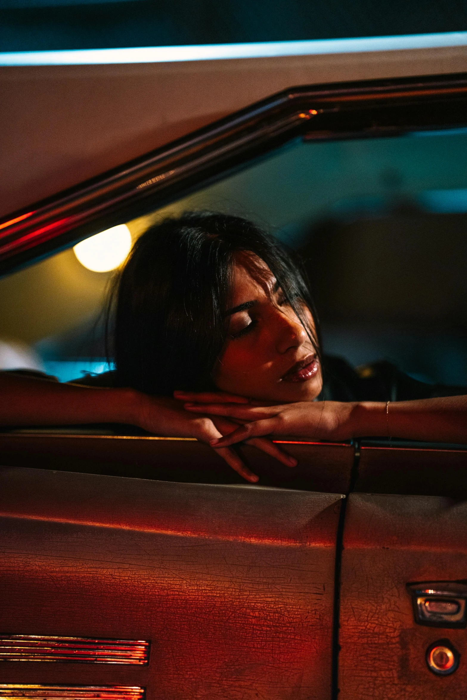 a woman leans out the window of a car