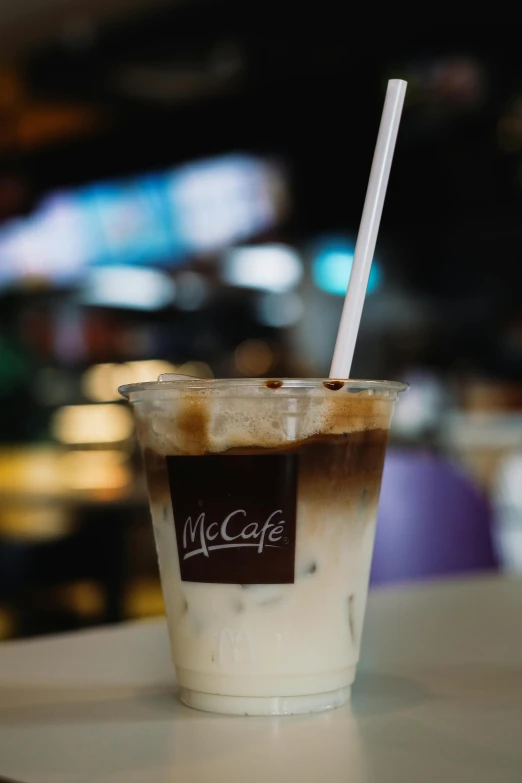 a cup of coffee sits on the table in a cafe