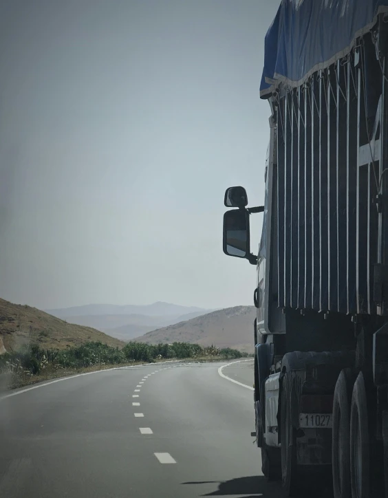 the front of a truck is seen on an empty road