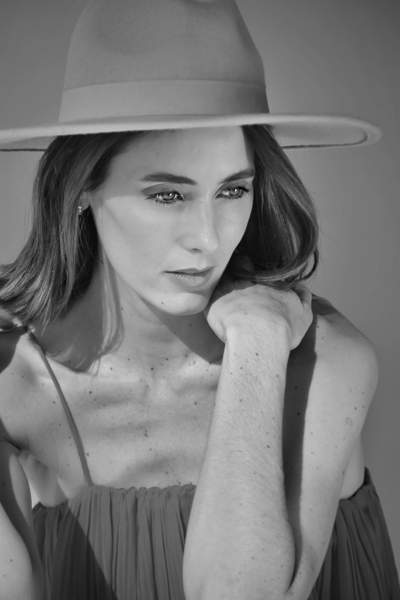 black and white pograph of a young woman in a fedora hat