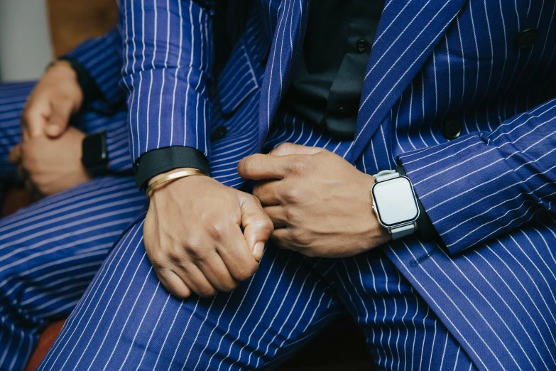 man in blue and white striped suit and black watch