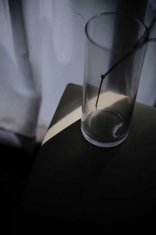 the shadow of a glass on top of a table