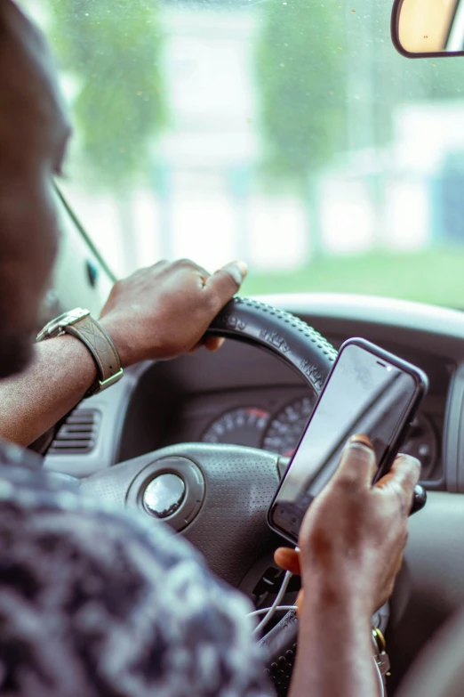 a person using a cell phone while in a vehicle