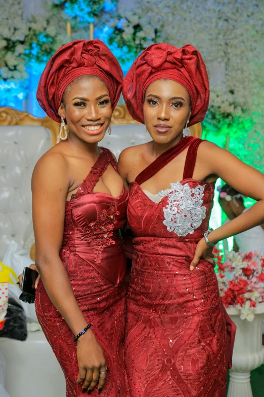 two women are dressed up in red dresses