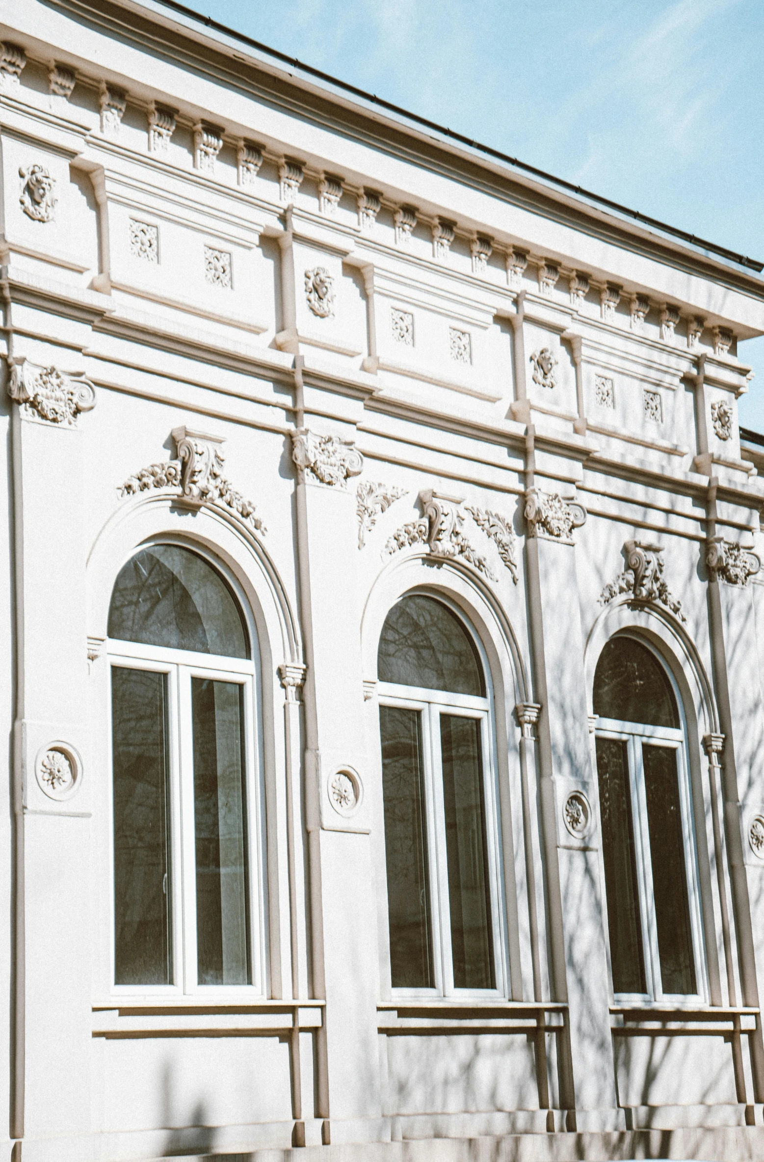 a white building with many windows and a clock