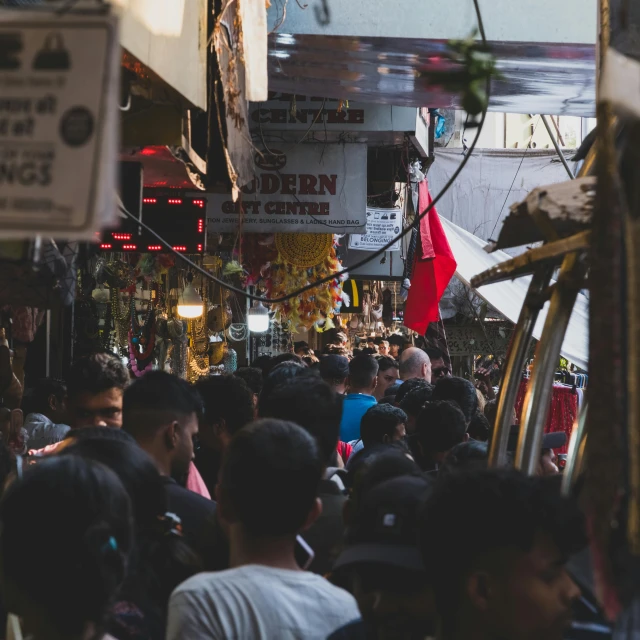 an outdoor market with lots of people and signs