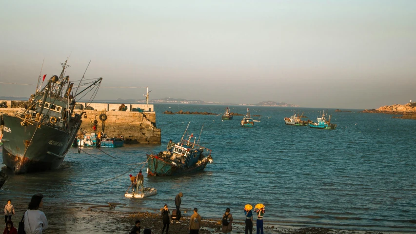 a fishing fleet in the ocean with two boats on the water