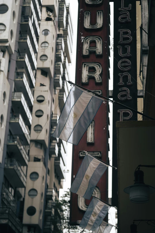 a sign that says river city bar with flags attached in front of it