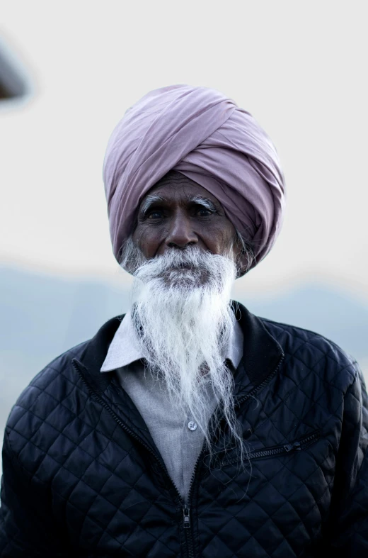 a man with a purple turban on his head