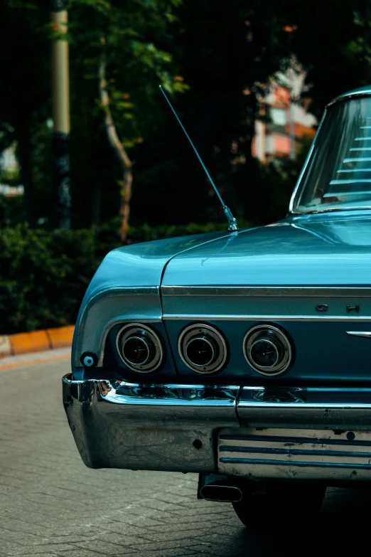 a blue car is parked with its hood open