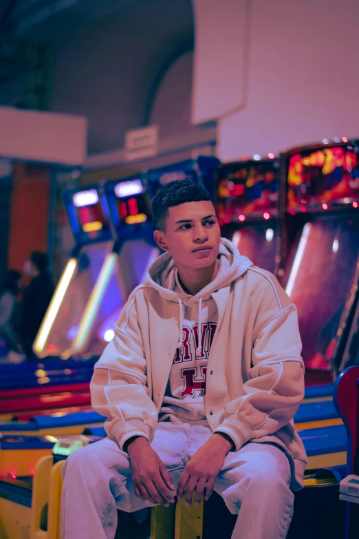 a man sitting on top of a chair wearing white clothes