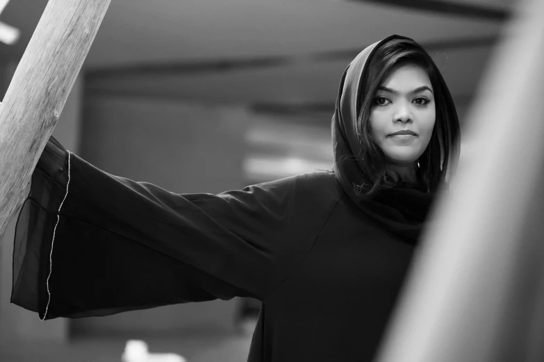 a woman holding a wooden pole in front of her face