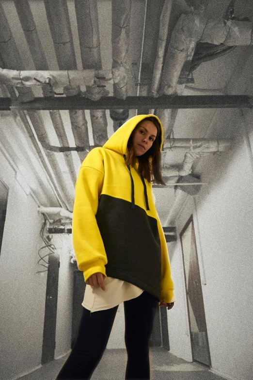 a girl dressed in yellow is holding a black board