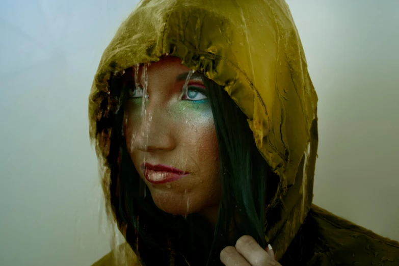 a woman with a raincoat and her hair flowing through the wind