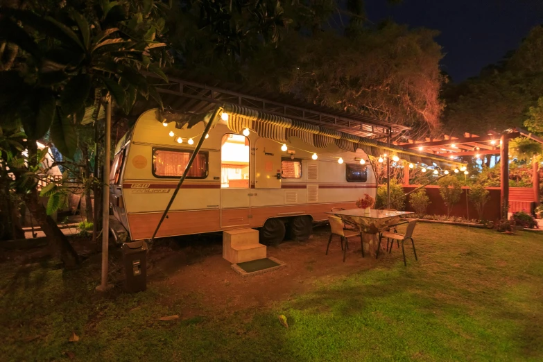 a camper on a trailer in the evening