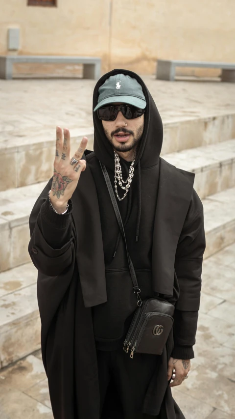 a man in a hoodie posing for the camera