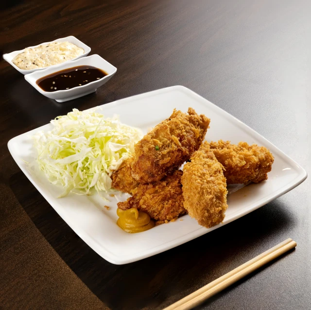 the square plate is filled with a meat and cabbage dish