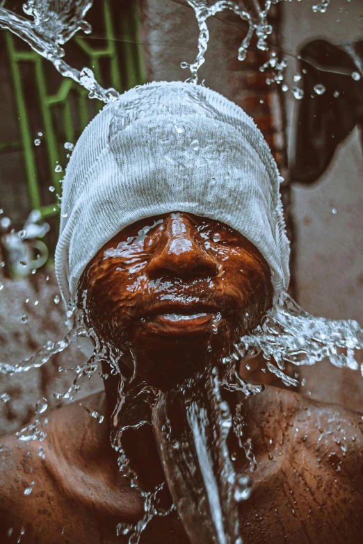 a man with his head covered in water