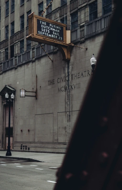 a dark street that has a theater marquee on it