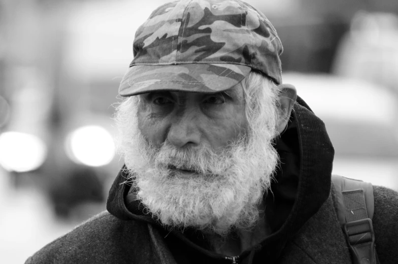 an old man with a beard and wearing a hat