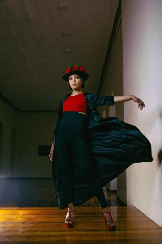 an oriental woman is dancing while wearing a red top