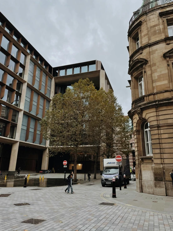 several buildings and pedestrians walking on a brick street