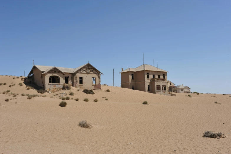 a desert that has two houses with roof tops on