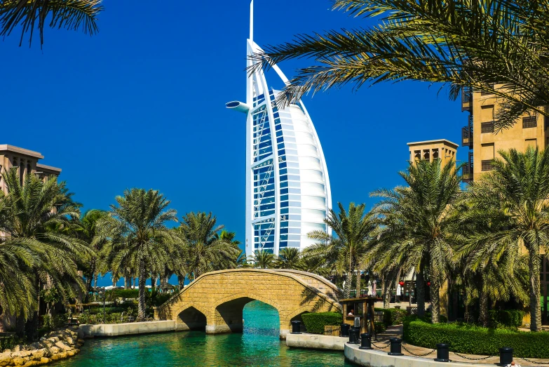 the burj el is behind some trees and buildings