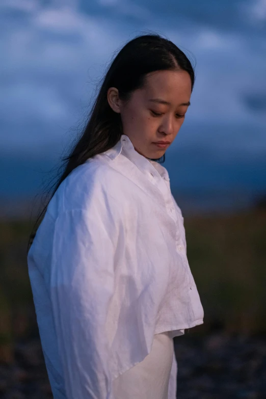 woman wearing white shirt standing by the water