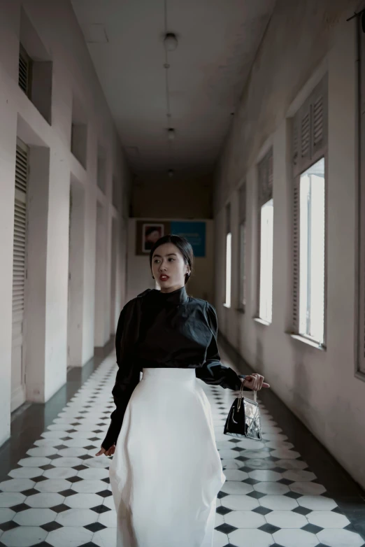 a woman is posing for a po in a hallway