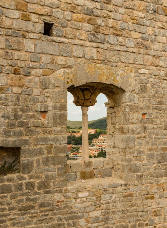 a small window inside of a large brick wall