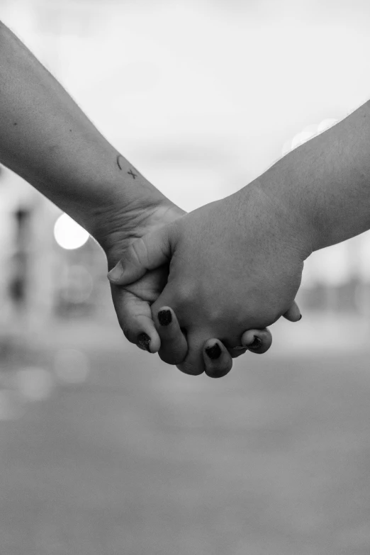 black and white po of a couple holding hands