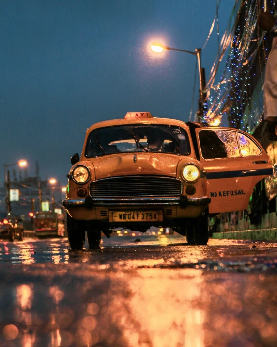 a taxi cab is parked in the rain