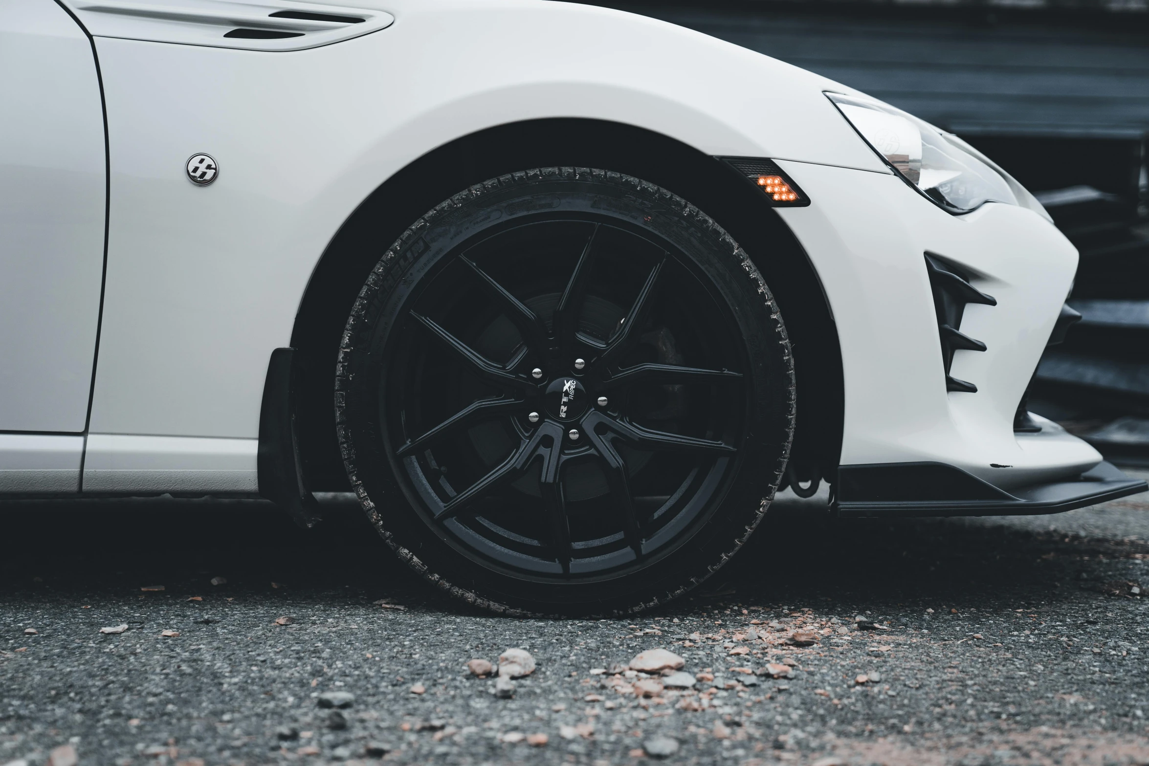 the front wheel of a white sports car