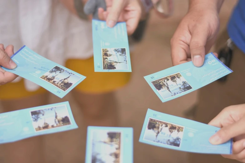 a group of people holding up some tickets