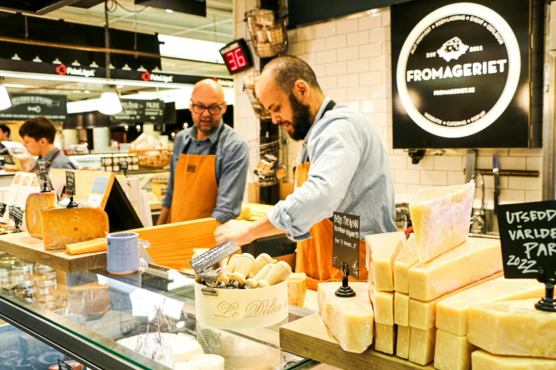 a man in glasses and some cheese at a store