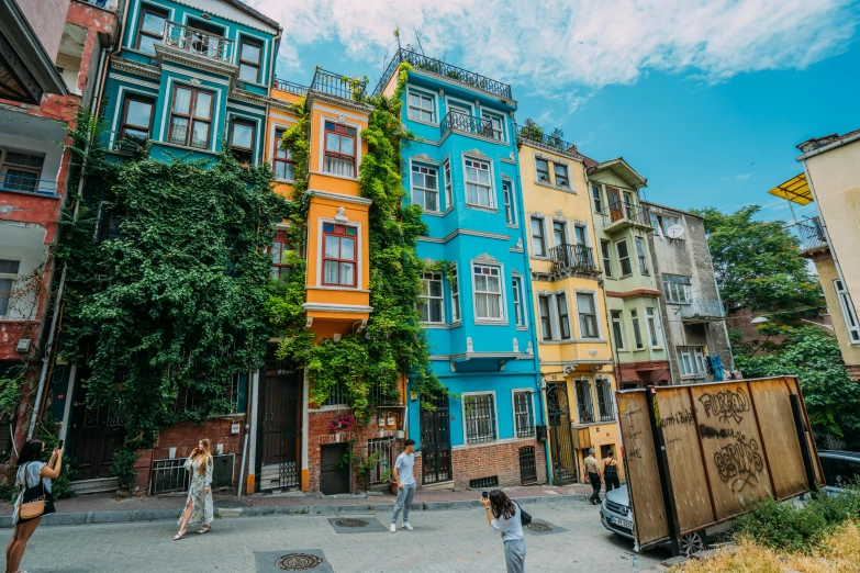 people standing around in front of a multi - colored building