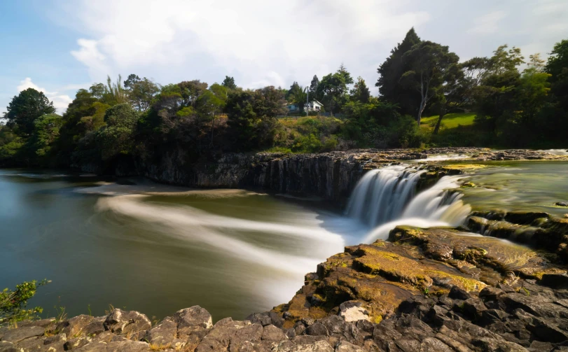 a waterfall pouring water into a body of water