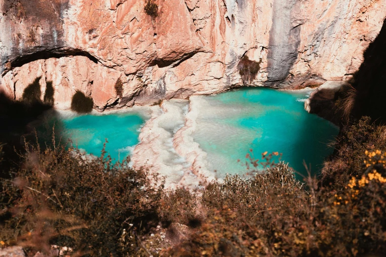 a lake sitting in a cave near a cliff