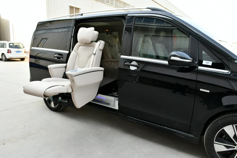 an electric passenger van parked outside near other vehicles