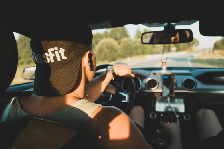 a woman driving on the road on her phone