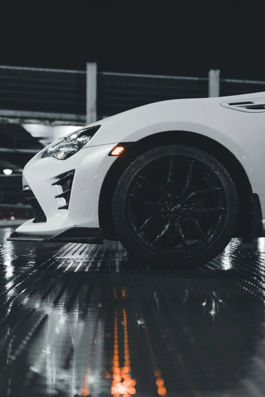 a white sports car parked inside a warehouse