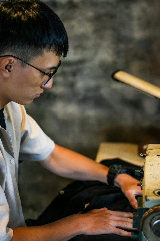 a man with glasses sitting at a table